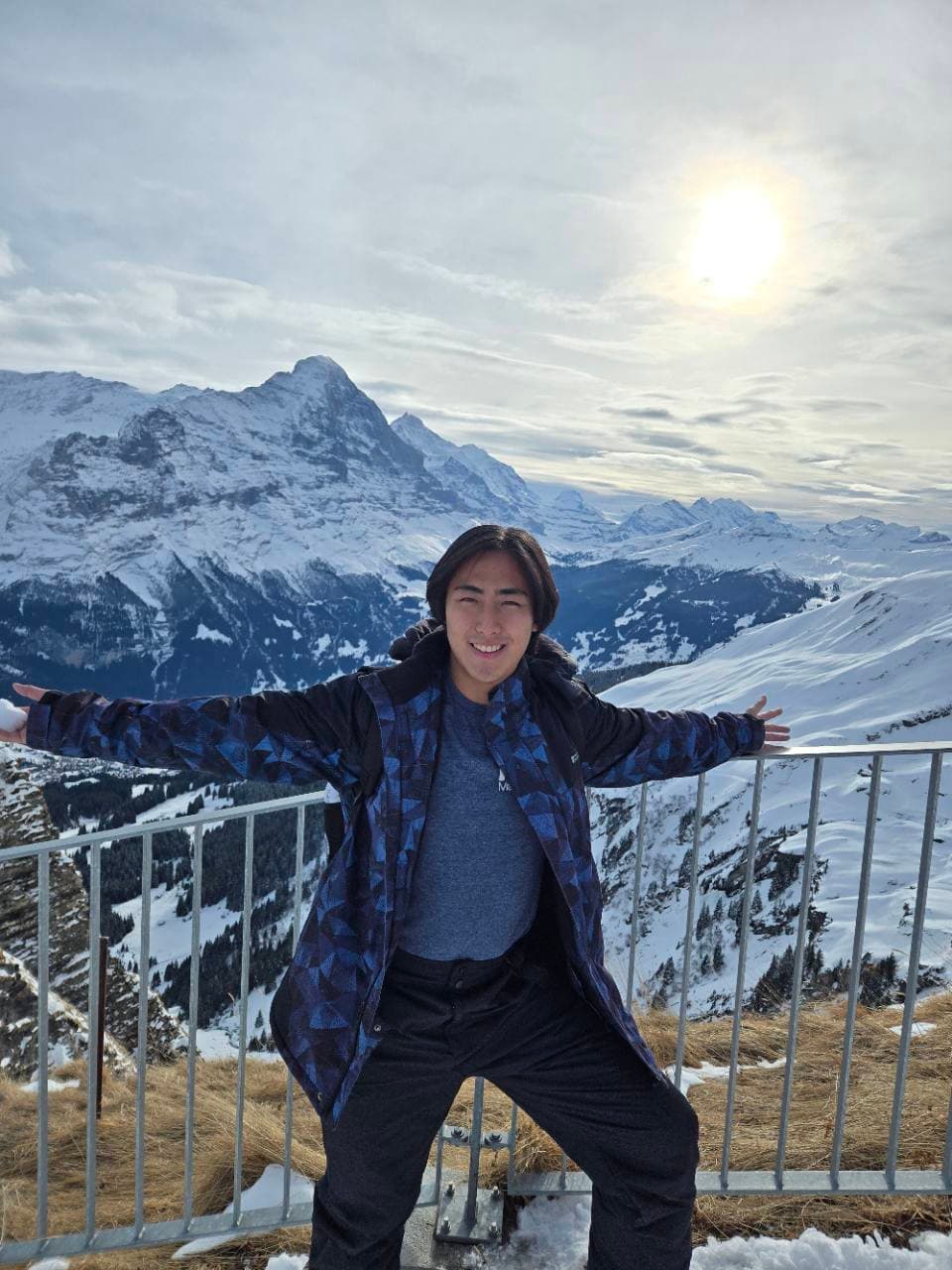 Max at a viewpoint above the snowy mountains in Grindelwald.